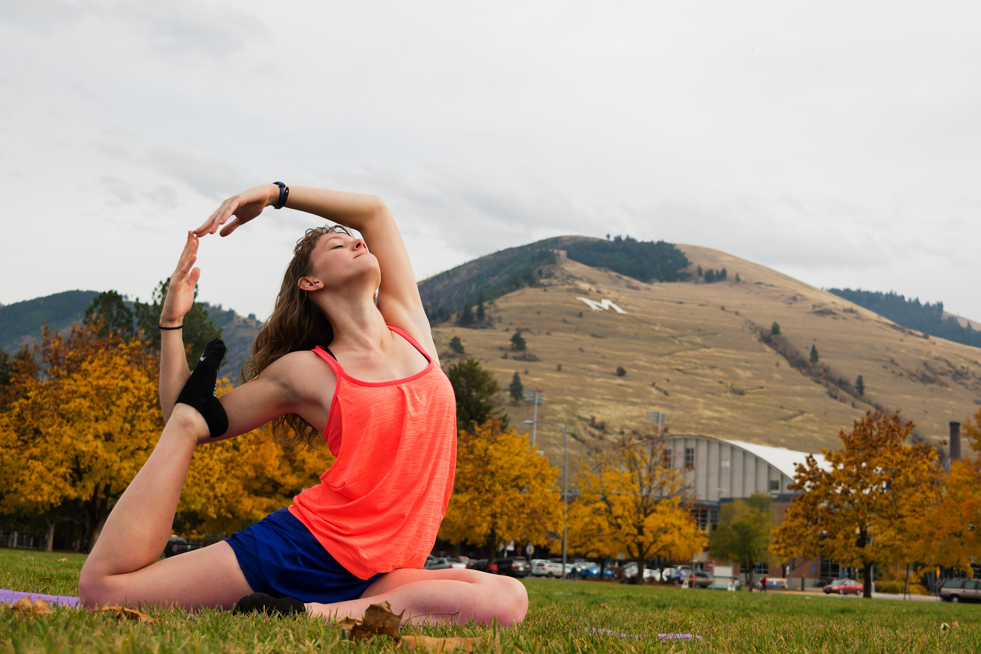 Delaney Rogers doing yoga with Mount Sentinel in the background