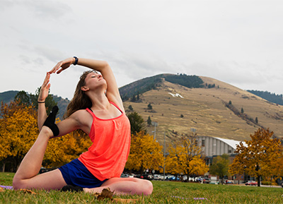 teen doing yoga with Mount Sentine in the background